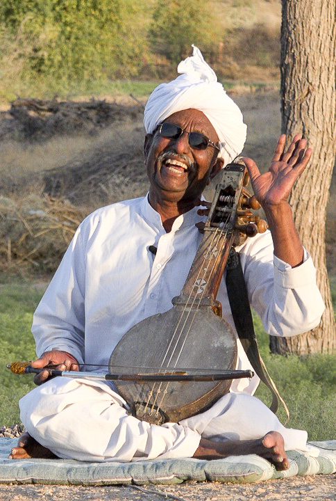 Manganiyar elder laughing with his Sarangi